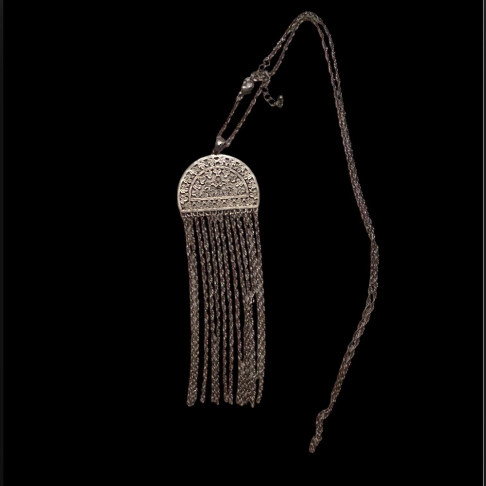 Pendant with intricate design and tassels